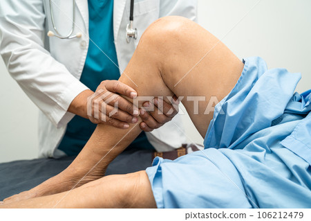 Asian elderly woman patient show her scars surgical total knee joint replacement Suture wound surgery arthroplasty on bed in hospital, healthy strong medical concept. 106212479