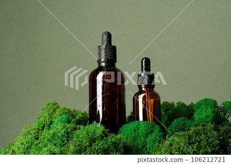 Vape smoking liquid bottles on moss background 106212721