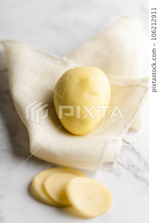 Potato and potato chips placed on a marble slab. 106212911