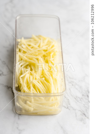 Shredded potato placed on a marble slab. Shredded potato placed on a marble slab. 106212996