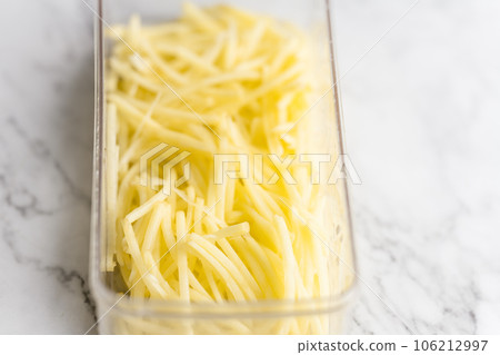 Shredded potato placed on a marble slab. Shredded potato placed on a marble slab. 106212997