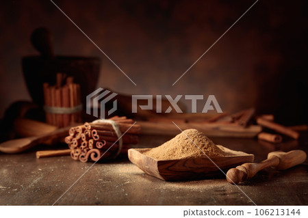 Cinnamon on an old wooden table. 106213144