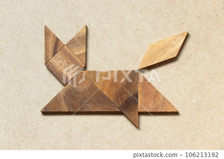 Wooden tangram in cat walking shape on wood background Wooden tangram in cat walking shape on wood background 106213192