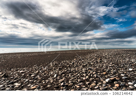 Diamond beach with iceberg and stone on volcanic black sand beach in summer on gloomy day Diamond beach with iceberg and stone on volcanic black sand beach in summer on gloomy day 106214642