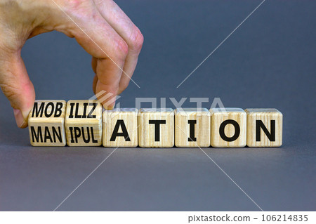 Mobilization or manipulation symbol. Concept words Mobilization Manipulation on wooden cubes. Beautiful grey background. Psychologist hand. Psychology mobilization manipulation concept. Copy space. Mobilization or manipulation symbol. Concept words Mobilization Manipulation on wooden cubes. Beautiful grey background. Psychologist hand. Psychology mobilization manipulation concept. Copy space. 106214835