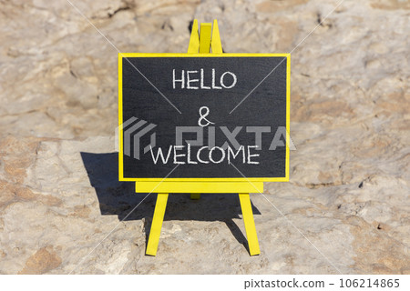 Hello and welcome symbol. Concept words Hello and welcome on black chalk blackboard on a beautiful stone background. Business hello and welcome concept. Copy space. Hello and welcome symbol. Concept words Hello and welcome on black chalk blackboard on a beautiful stone background. Business hello and welcome concept. Copy space. 106214865