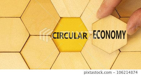 Circular economy symbol. Concept words Circular economy on beautiful wooden puzzles. Beautiful yellow background. Businessman hand. Business circular economy concept. Copy space. Circular economy symbol. Concept words Circular economy on beautiful wooden puzzles. Beautiful yellow background. Businessman hand. Business circular economy concept. Copy space. 106214874