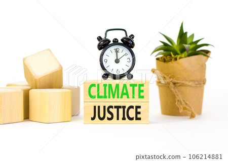 Climate justice symbol. Concept words Climate justice on beautiful wooden blocks. Beautiful white table white background. Black alarm clock. Business environment climate justice concept. Copy space. 106214881