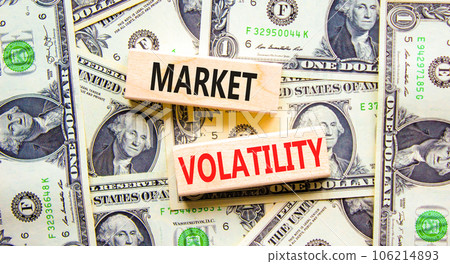 Market volatility symbol. Concept words Market volatility on beautiful wooden blocks. Dollar bills. Beautiful background from dollar bills. Business market volatility concept. Copy space.orange 106214893