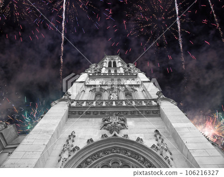 Celebratory fireworks over the Great gothic church of Saint Germain l Auxerrois, Paris, France 106216327