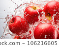 Fresh red apples in water splash on blue background, close-up 106216605