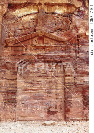 Wall with the door, the entrance to the temple, carved into the red sandstone rock in the canyon. Wall with the door, the entrance to the temple, carved into the red sandstone rock in the canyon. 106217161
