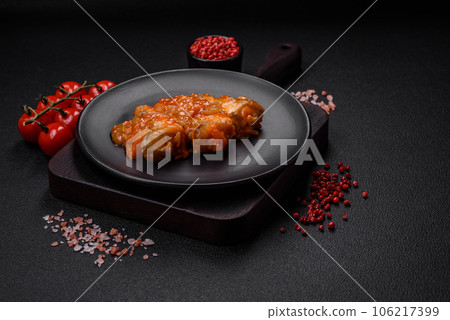 Delicious fresh sea fish cut into pieces and baked in tomato sauce 106217399