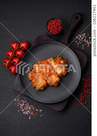 Delicious fresh sea fish cut into pieces and baked in tomato sauce Delicious fresh sea fish cut into pieces and baked in tomato sauce 106217401