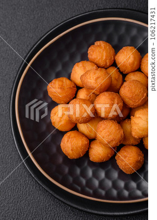 Delicious fried potato balls with breaded mozzarella, salt, spices and herbs 106217431