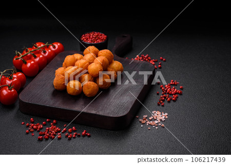 Delicious fried potato balls with breaded mozzarella, salt, spices and herbs Delicious fried potato balls with breaded mozzarella, salt, spices and herbs 106217439