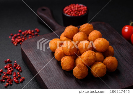 Delicious fried potato balls with breaded mozzarella, salt, spices and herbs 106217445