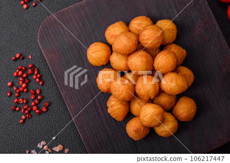 Delicious fried potato balls with breaded mozzarella, salt, spices and herbs 106217447