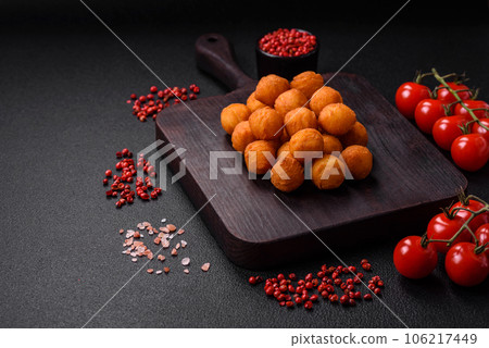 Delicious fried potato balls with breaded mozzarella, salt, spices and herbs 106217449