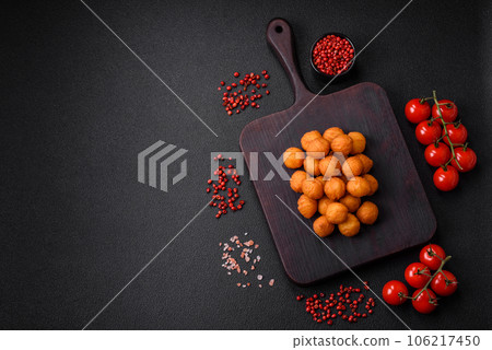 Delicious fried potato balls with breaded mozzarella, salt, spices and herbs 106217450