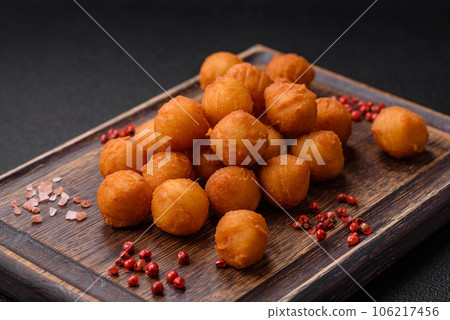 Delicious fried potato balls with breaded mozzarella, salt, spices and herbs Delicious fried potato balls with breaded mozzarella, salt, spices and herbs 106217456