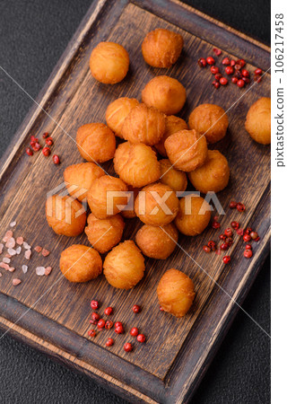 Delicious fried potato balls with breaded mozzarella, salt, spices and herbs 106217458