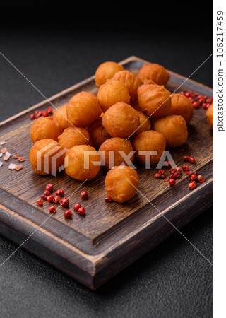 Delicious fried potato balls with breaded mozzarella, salt, spices and herbs 106217459