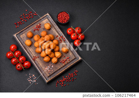 Delicious fried potato balls with breaded mozzarella, salt, spices and herbs 106217464