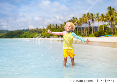 Child on tropical beach. Sea vacation with kids. 106217674