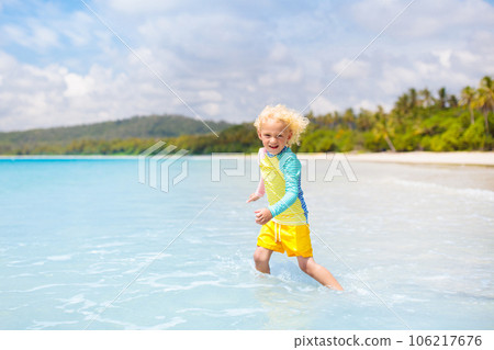 Child on tropical beach. Sea vacation with kids. 106217676