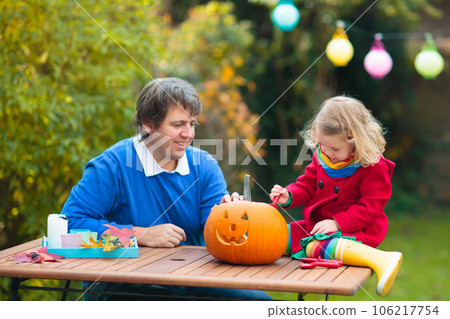 Family carving Halloween pumpkin. Family carving Halloween pumpkin. 106217754