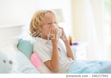 Sick child in bed. Mother checking on unwell kid. Sick child in bed. Mother checking on unwell kid. 106217942