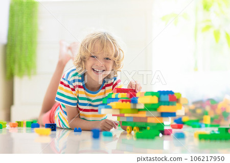Child playing with toy blocks. Toys for kids. 106217950