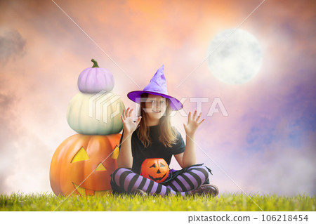 Child and on giant pumpkin lantern on Halloween 106218454