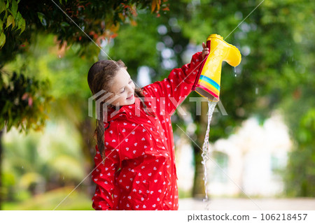 Kid with rain boots. Waterproof wear for children. Kid with rain boots. Waterproof wear for children. 106218457