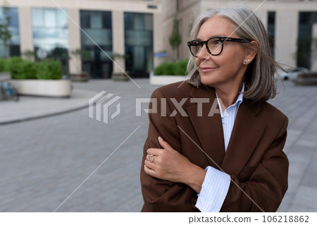 portrait of a successful well-groomed pretty gray-haired woman pensioner dressed in an elegant suit portrait of a successful well-groomed pretty gray-haired woman pensioner dressed in an elegant suit 106218862