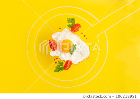 Fried egg food styling with tomatoes cherry and persil in pan drawn by chalk Fried egg food styling with tomatoes cherry and persil in pan drawn by chalk 106218951