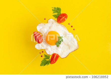 Fried egg food styling with tomatoes cherry and persil Fried egg food styling with tomatoes cherry and persil 106218952