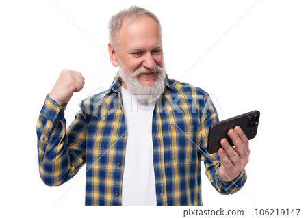 smiling kind 50s mid aged gray-haired man with beard watching video on smartphone on white 106219147