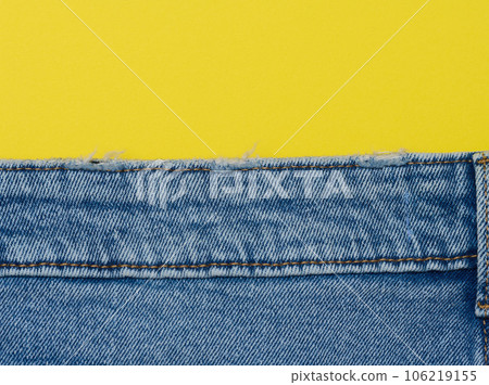 Blue jeans on a yellow background, copy space Blue jeans on a yellow background, copy space 106219155
