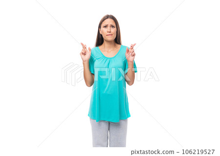 30 year old pretty brunette woman with black flowing hair crossed her fingers and hope for good luck 30 year old pretty brunette woman with black flowing hair crossed her fingers and hope for good luck 106219527