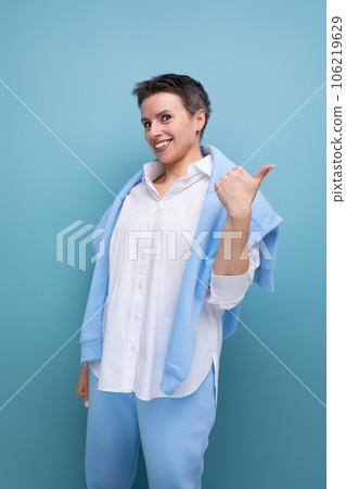 a bright young woman with a short haircut charismatically points her finger at space 106219629