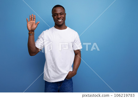 nice young african guy in white t-shirt waving his hand nice young african guy in white t-shirt waving his hand 106219783