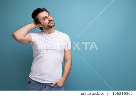 smart young man in a white t-shirt with an idea on a studio background with copyspace 106219865