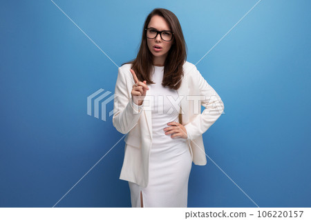 indignant brunette woman in white dress on studio background indignant brunette woman in white dress on studio background 106220157