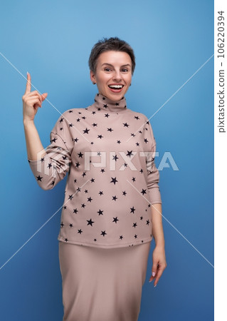 pretty young european woman with short dark hair in a casual suit with a skirt 106220394