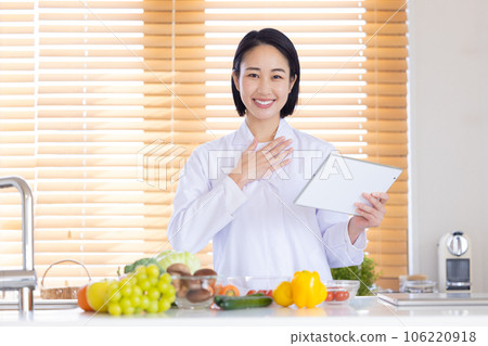 nutritionist looking at tablet 106220918