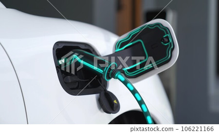 Electric car plugged in with home charging station. Peruse Electric car plugged in with home charging station. Peruse 106221166