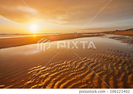 Atlantic ocean sunset with surging waves at Fonte da Telha beach, Costa da Caparica, Portugal Atlantic ocean sunset with surging waves at Fonte da Telha beach, Costa da Caparica, Portugal 106221402