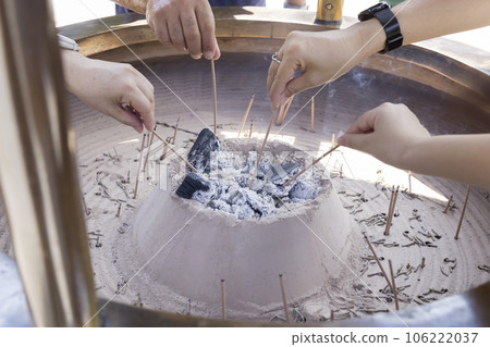A family lighting incense in the Jokoro at Chusonji Temple A family lighting incense in the Jokoro at Chusonji Temple 106222037